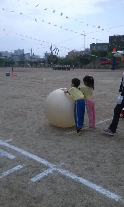 The first-graders had to roll this giant ball around a cone and back in pairs. It was unbelievably adorable.