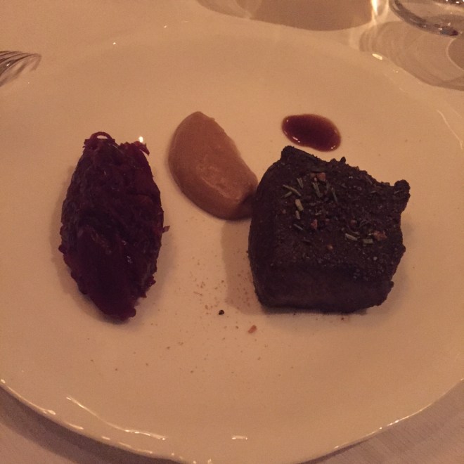 Venison encrusted with juniper berries served with venison jou, an emulsion of chestnuts and poblano peppers and caramelized red cabbage.